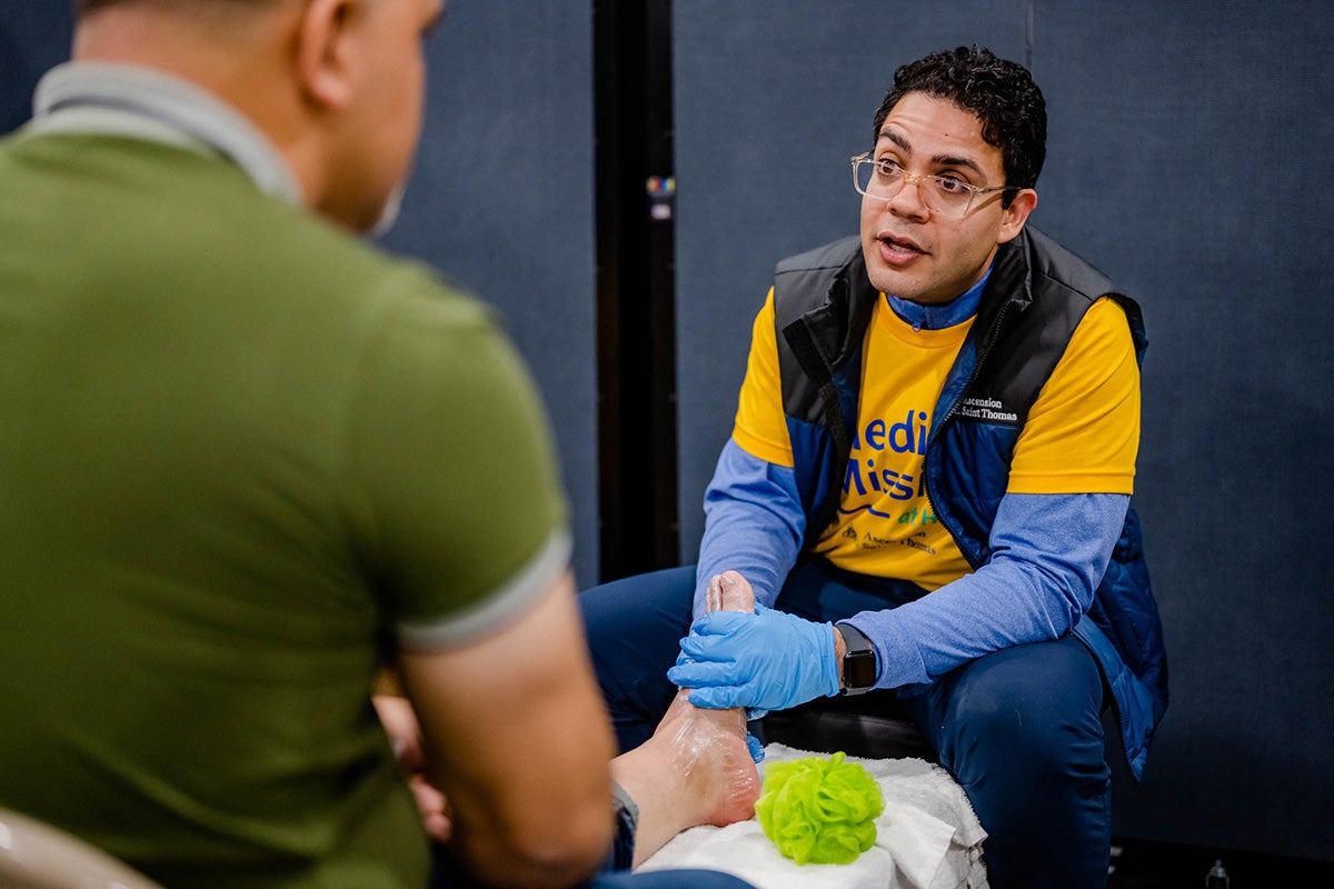 Volunteer assisting patient