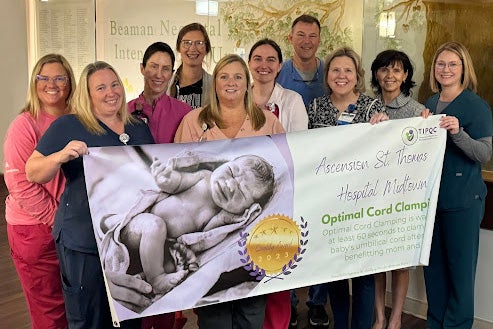 Associates holding a banner