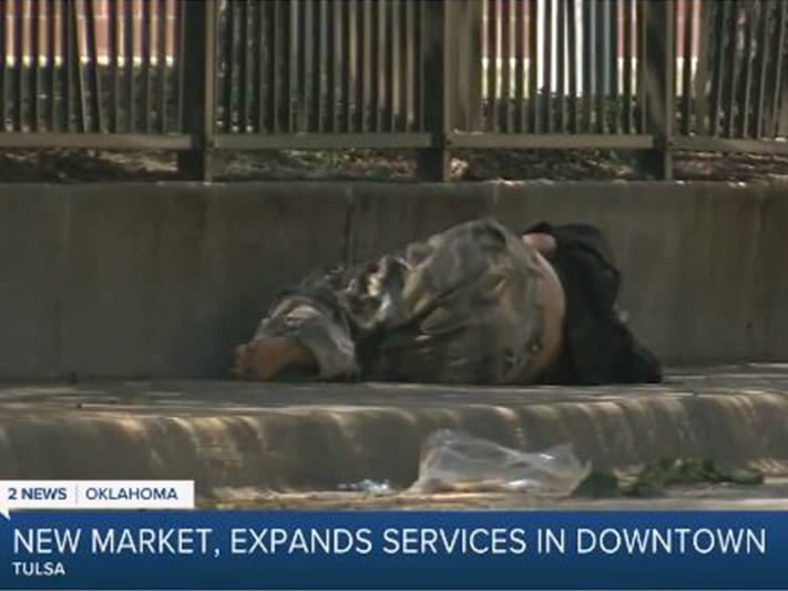 homeless person sleeping on the ground